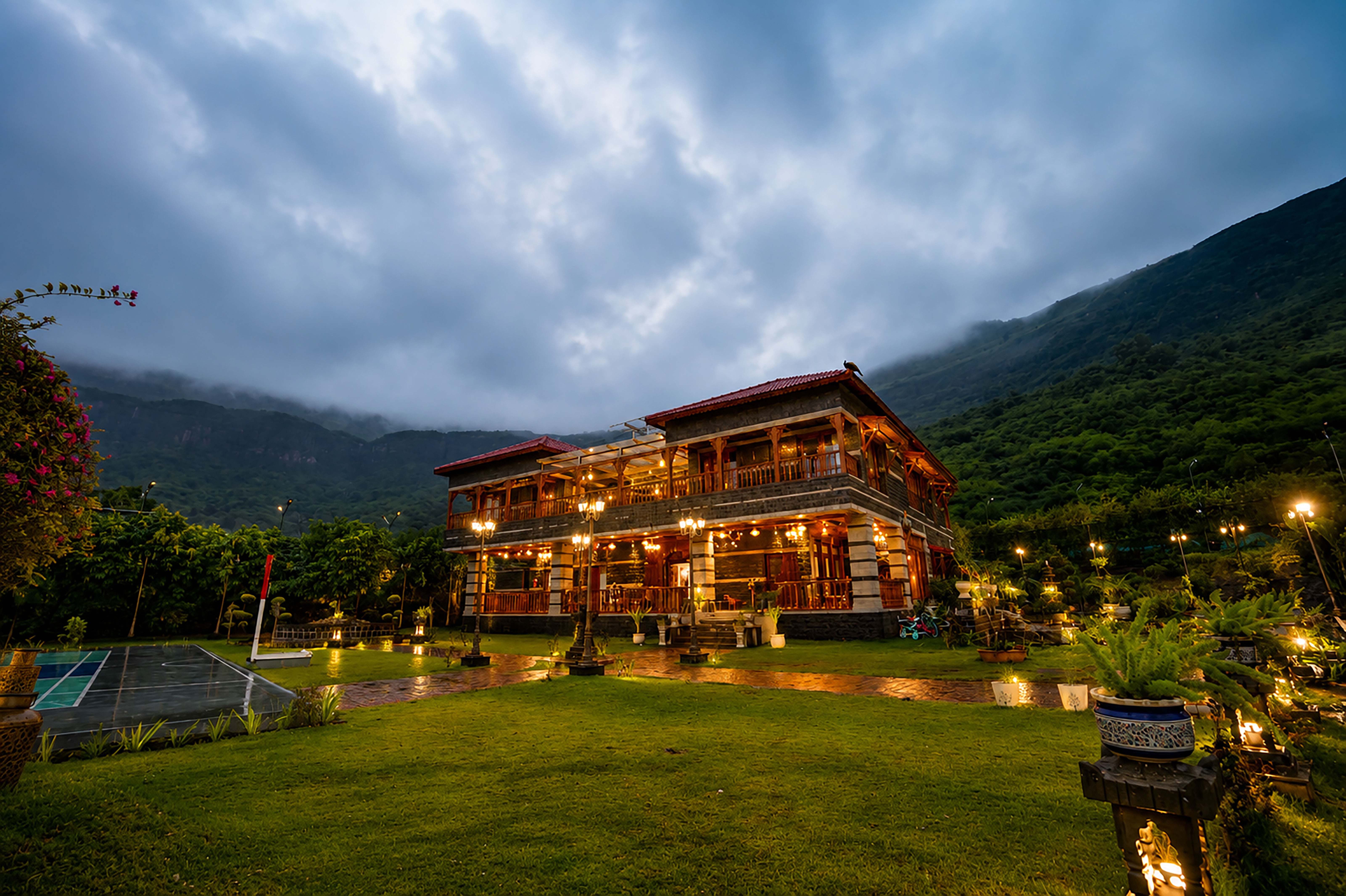 Front facade of Divine Homestay with mountains behind