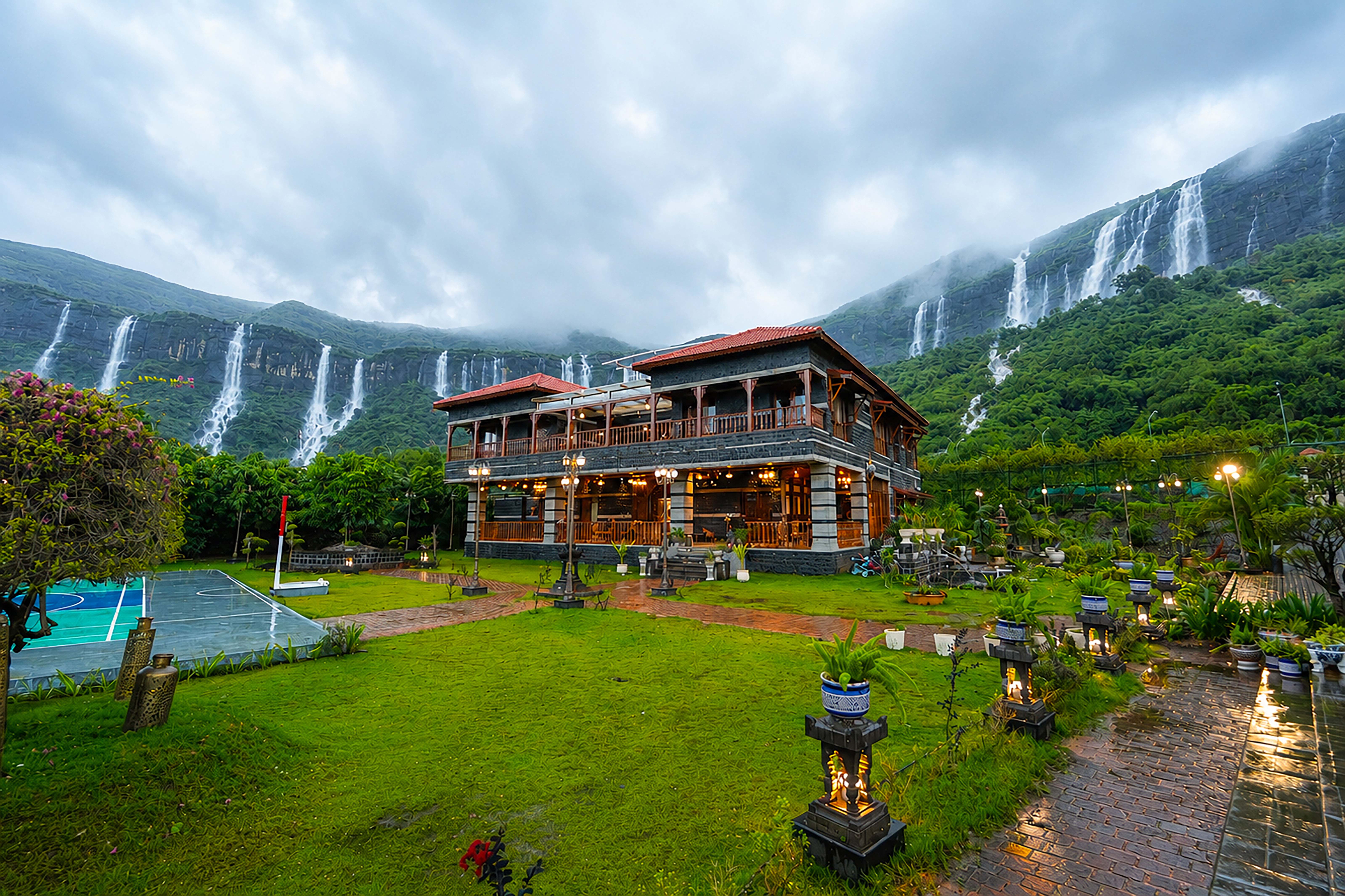 Divine Homestay lit up in the evening with lawns